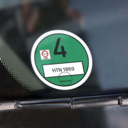 Umweltplakette auf Fahrzeugwindschutzscheibe Grüne Umweltplakette auf der Windschutzscheibe eines Fahrzeugs