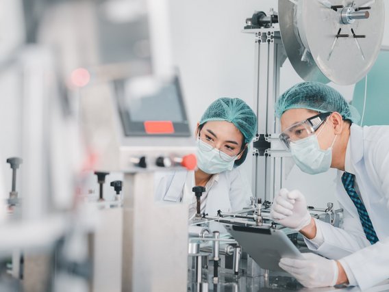 Scientists examine a machine Scientists examine a machine