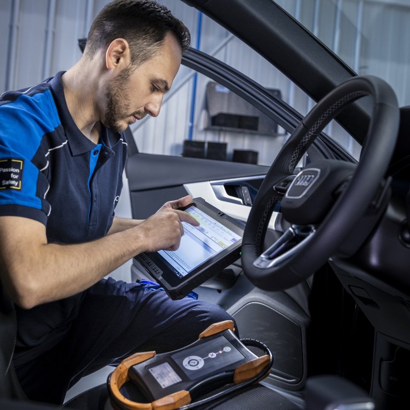 TÜV NORD Fahrzeugdiagnose mit moderner Technologie TÜV NORD Fahrzeugdiagnose mit Tablet im Innenraum eines Autos